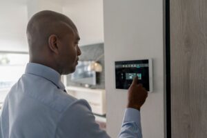 Real estate agent locking the door of a house using a home automation system